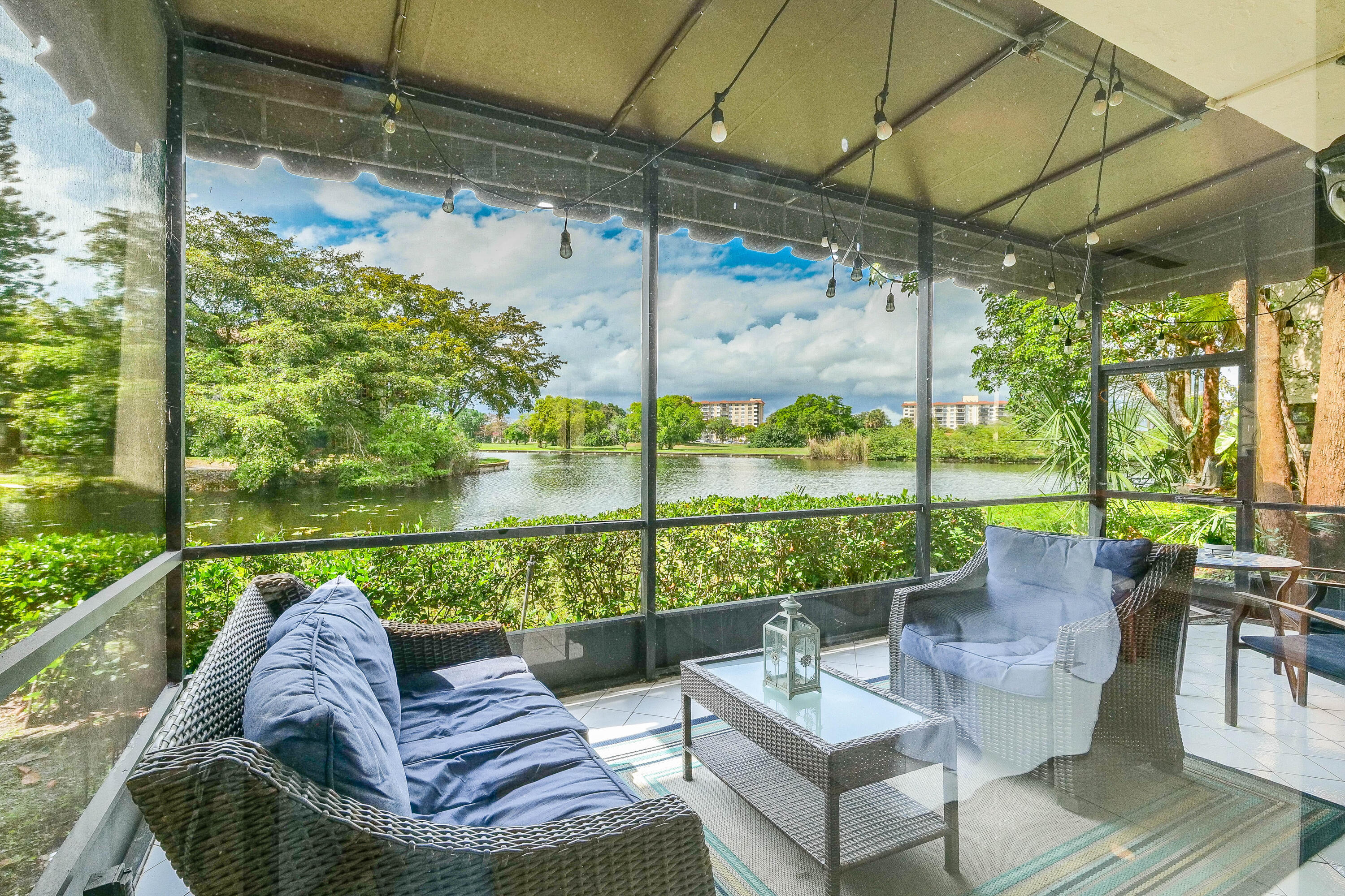 a view of a porch with furniture and a yard