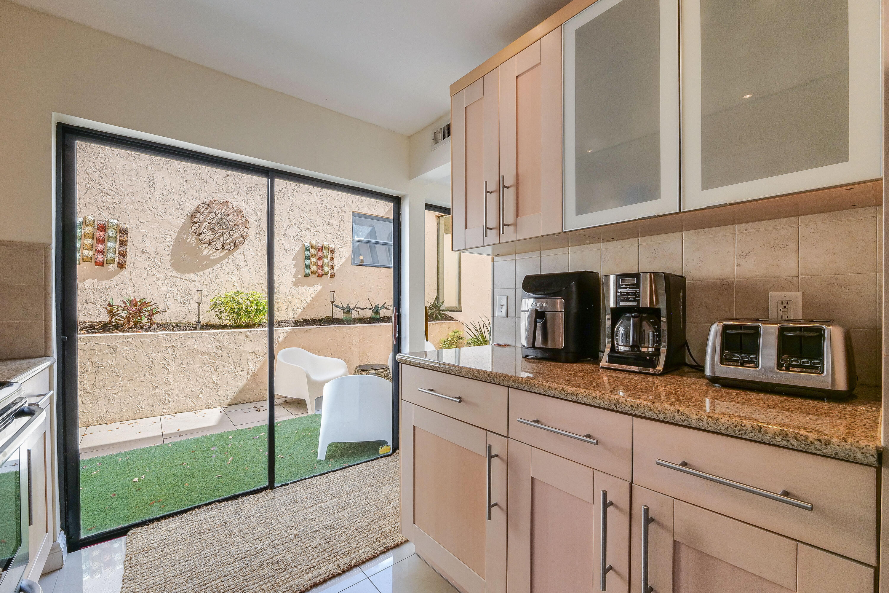5523 Constant Spring Terrace, Unit 222 Lauderhill, FL 33319 - Photo 11 of 60 a kitchen with stainless steel appliances granite countertop a stove a sink and a large window