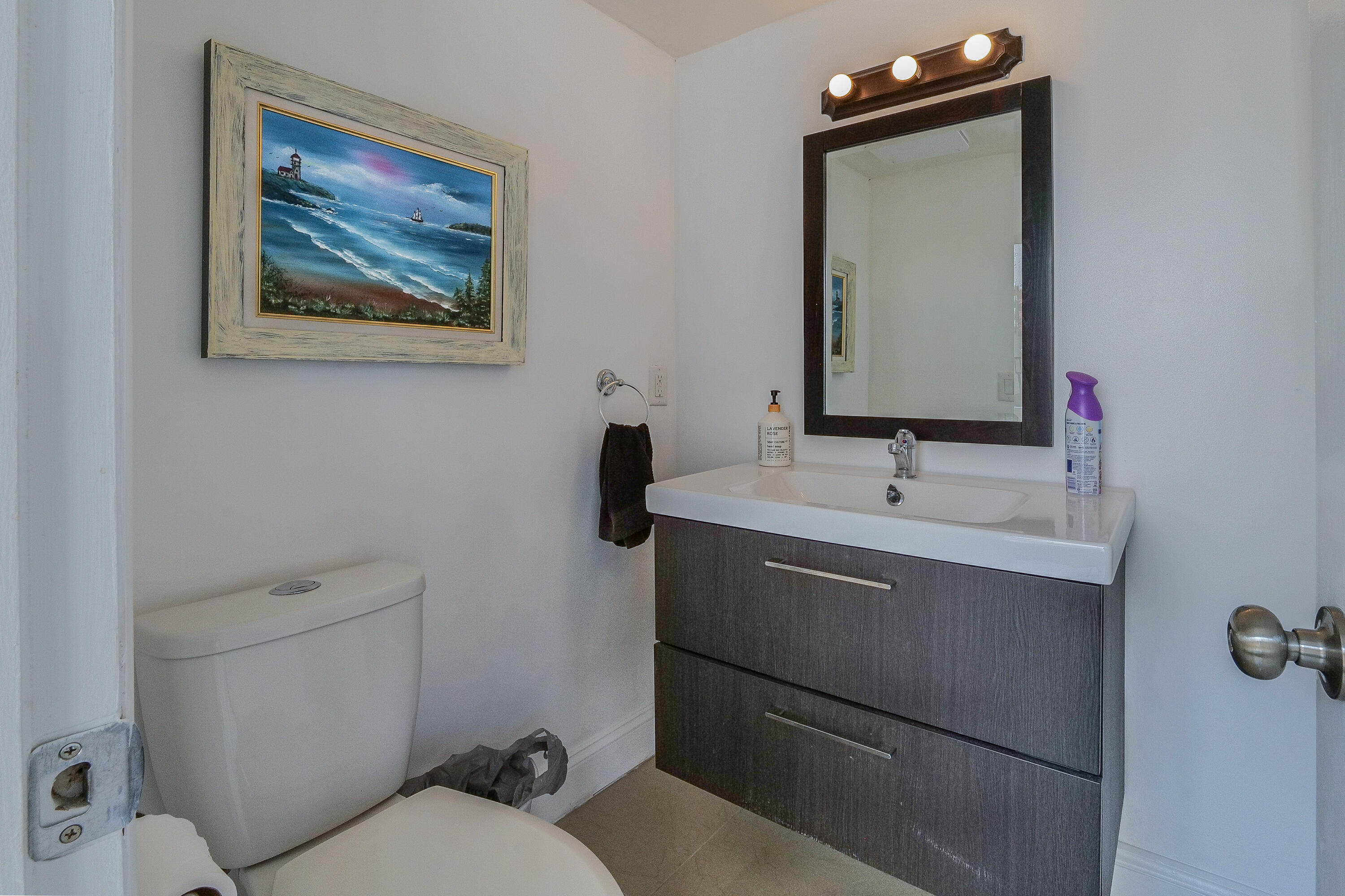 5523 Constant Spring Terrace, Unit 222 Lauderhill, FL 33319 - Photo 14 of 60 a bathroom with a toilet sink and mirror