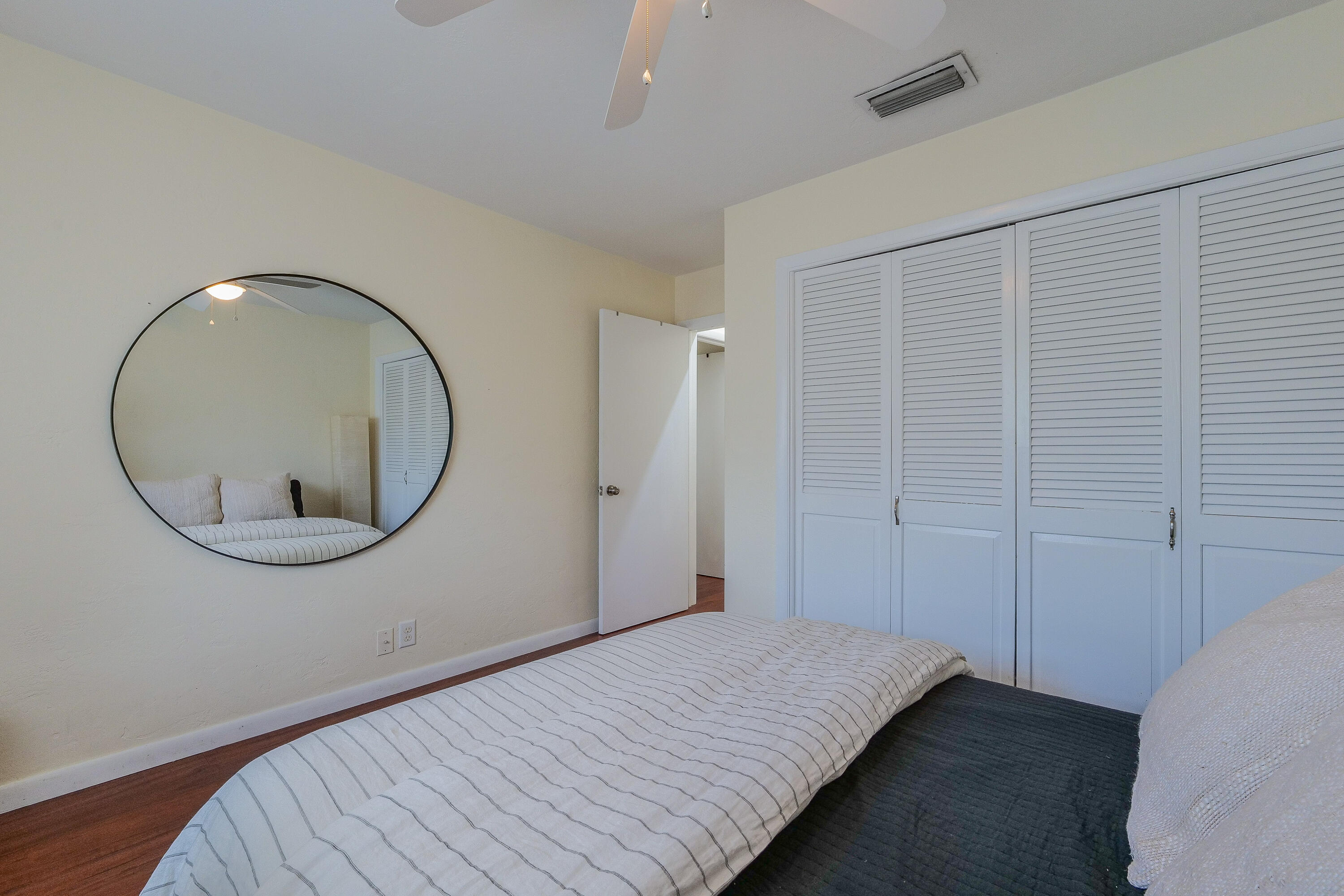 5523 Constant Spring Terrace, Unit 222 Lauderhill, FL 33319 - Photo 22 of 60 a bedroom with a bed and a mirror