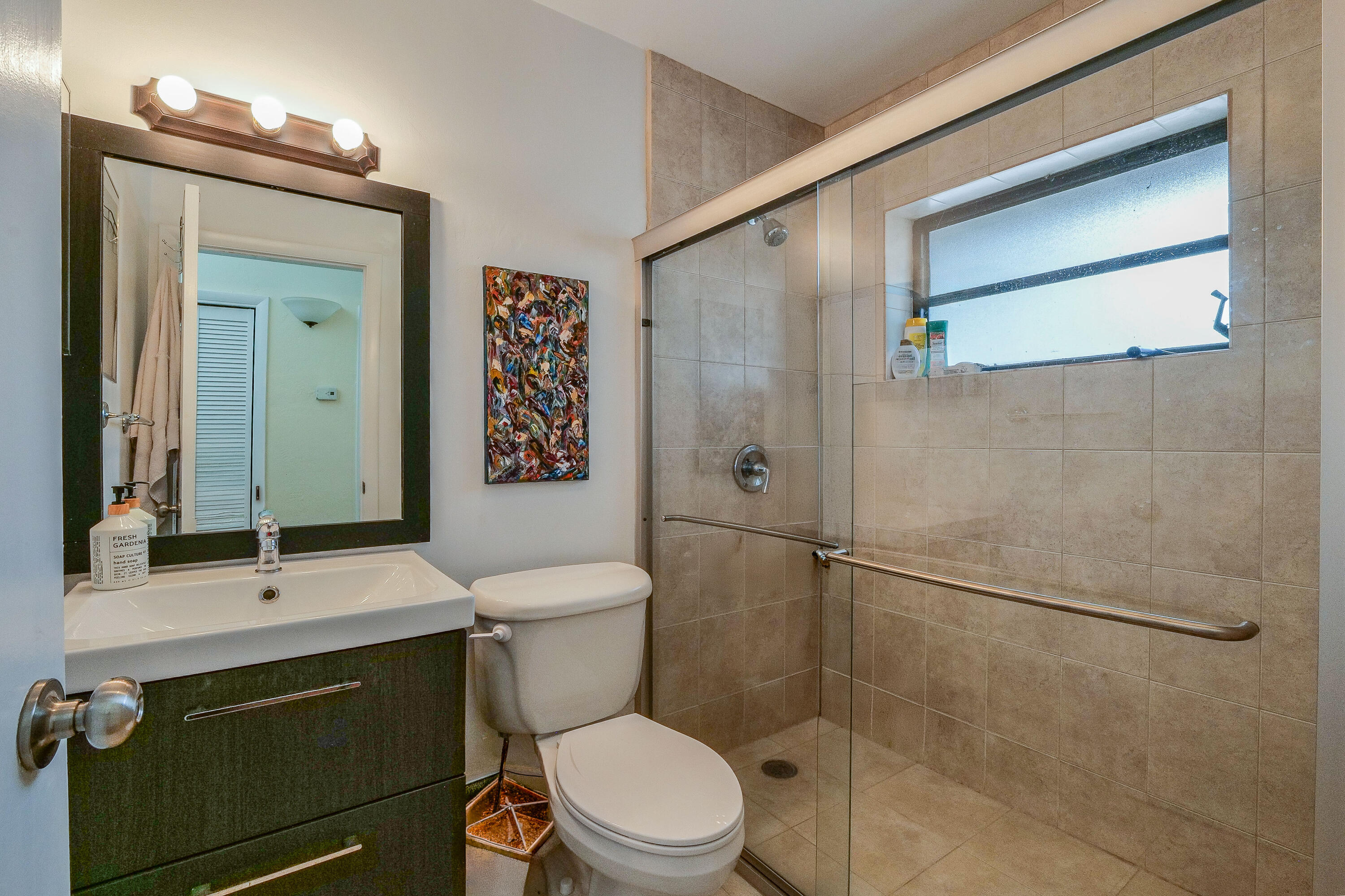 5523 Constant Spring Terrace, Unit 222 Lauderhill, FL 33319 - Photo 23 of 60 a bathroom with a toilet a sink and shower