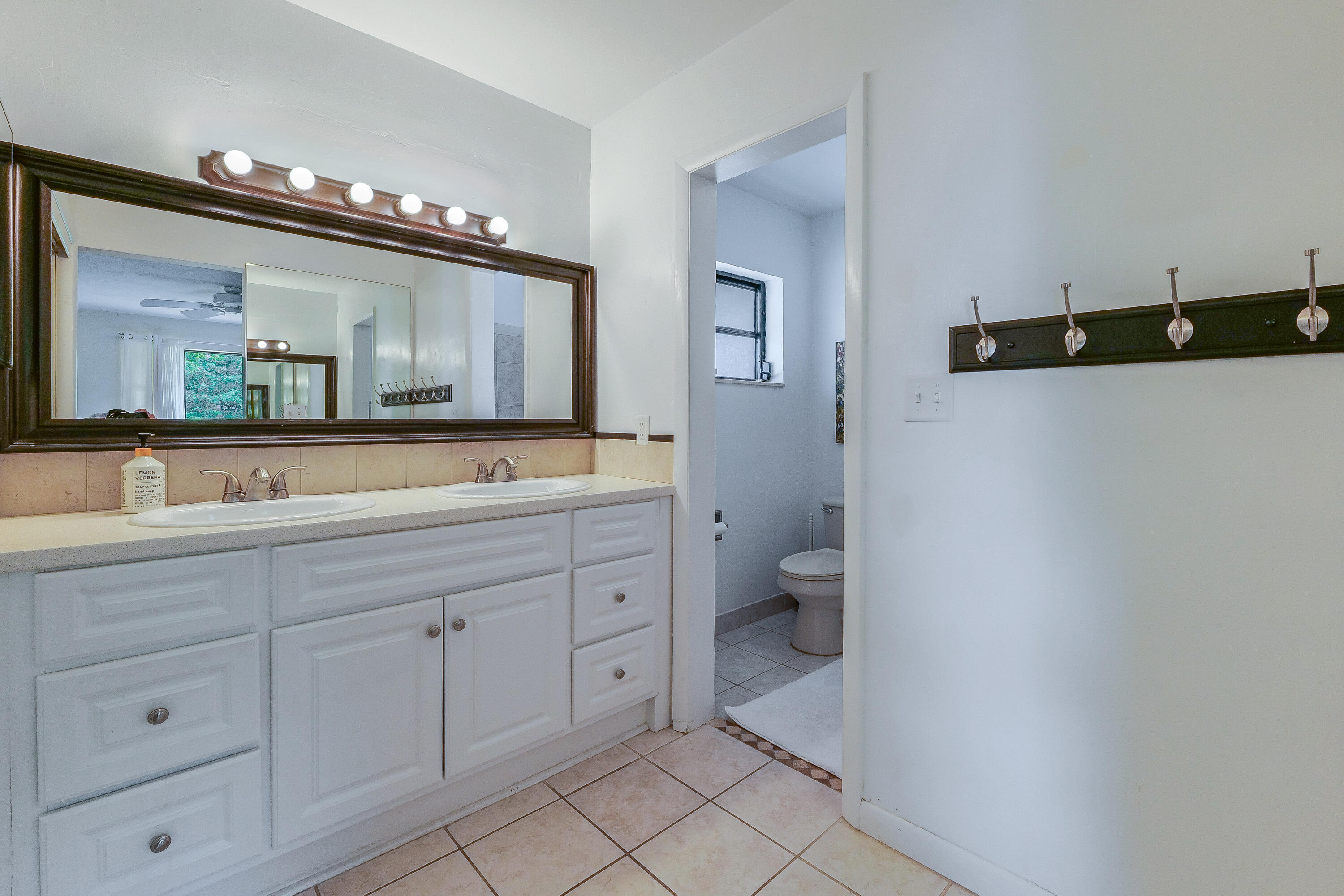 5523 Constant Spring Terrace, Unit 222 Lauderhill, FL 33319 - Photo 28 of 60 a spacious bathroom with a double vanity sink a mirror and toilet