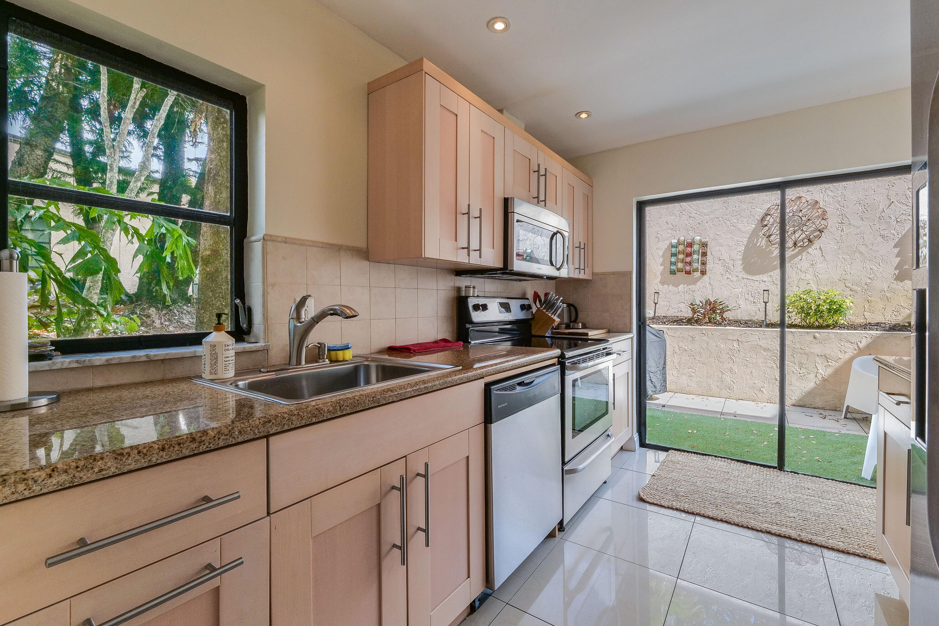 5523 Constant Spring Terrace, Unit 222 Lauderhill, FL 33319 - Photo 5 of 60 a kitchen with a sink window and cabinets