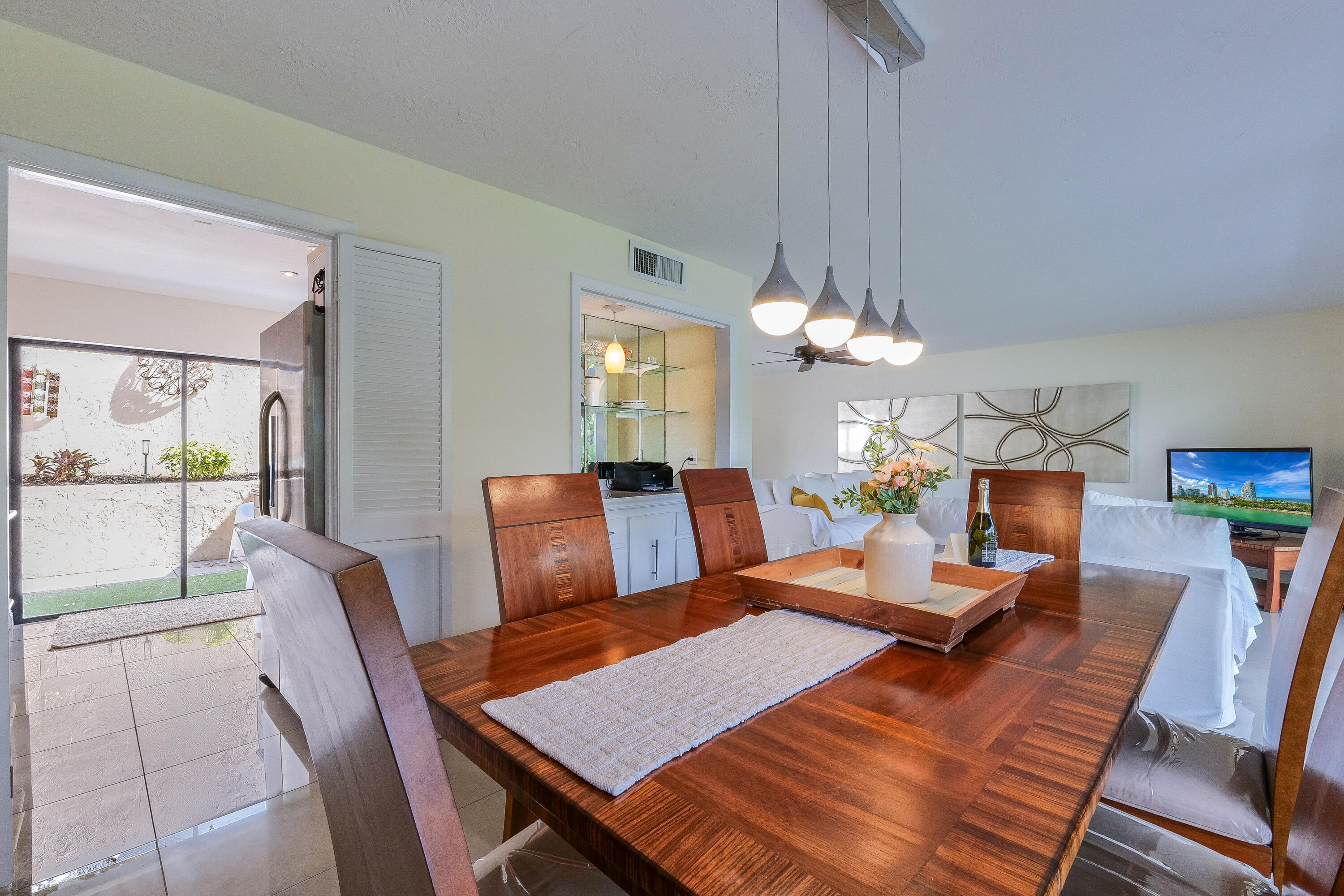 5523 Constant Spring Terrace, Unit 222 Lauderhill, FL 33319 - Photo 10 of 60 a view of a dining room with furniture a chandelier and wooden floor