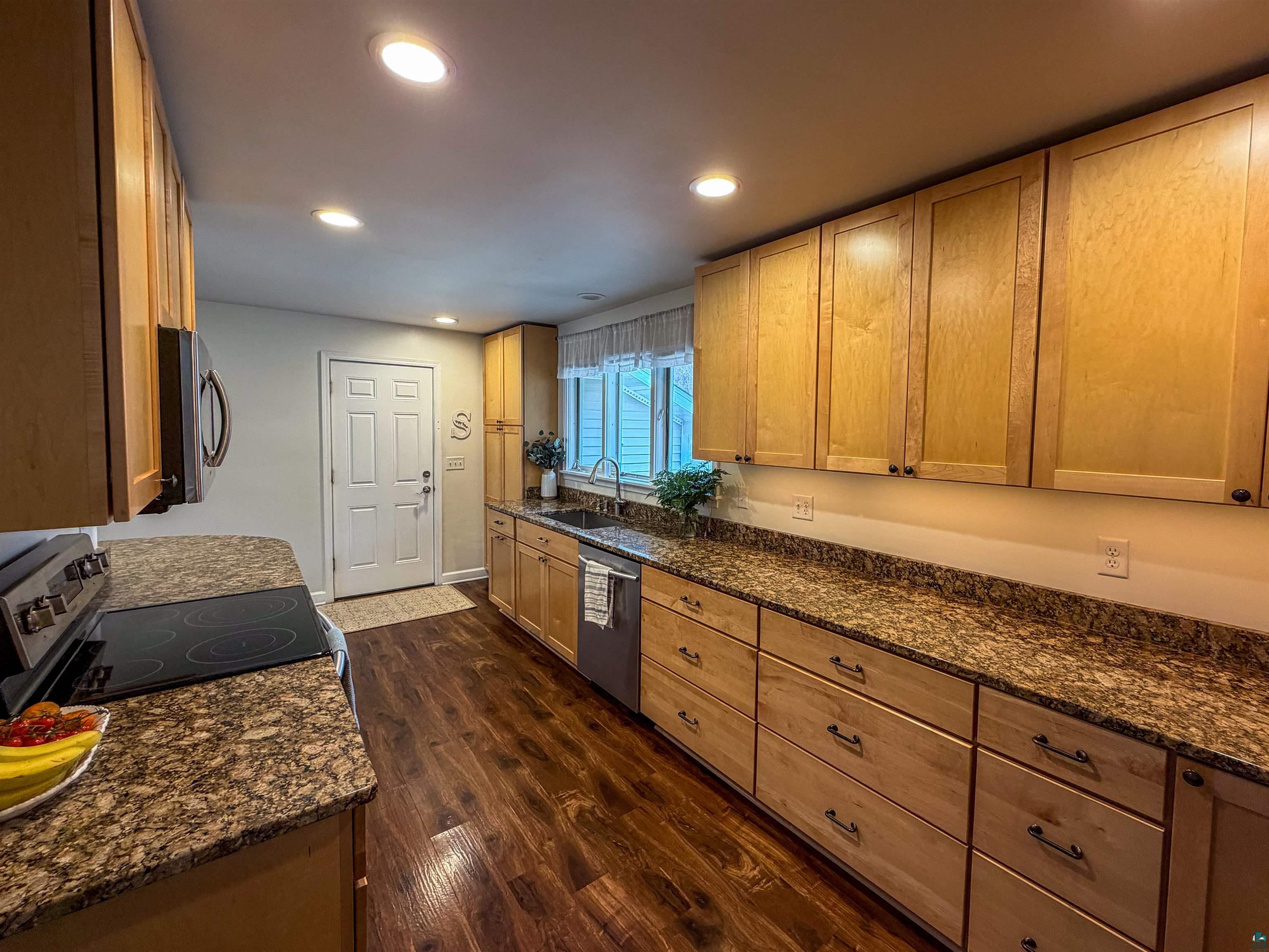 3704 Greysolon Road Duluth, MN 55804 - Photo 7 of 51 Kitchen featuring wood-finish flooring, recessed lighting, and light wood cabinetry with dark hardware