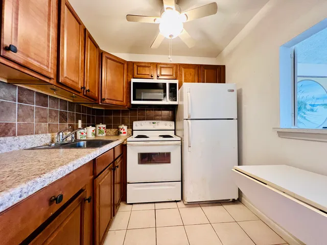 a kitchen with stainless steel appliances a refrigerator sink and microwave