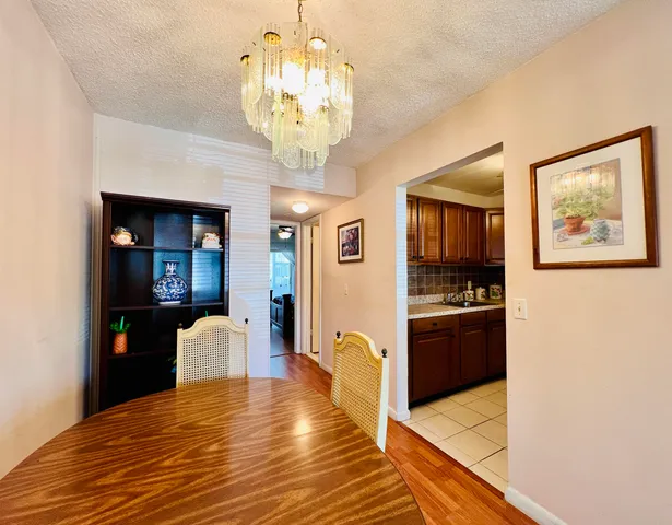 a view of a kitchen with stainless steel appliances granite countertop a refrigerator and a stove top oven