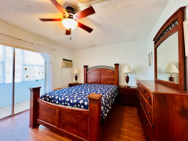 a bedroom with a bed a window and dresser