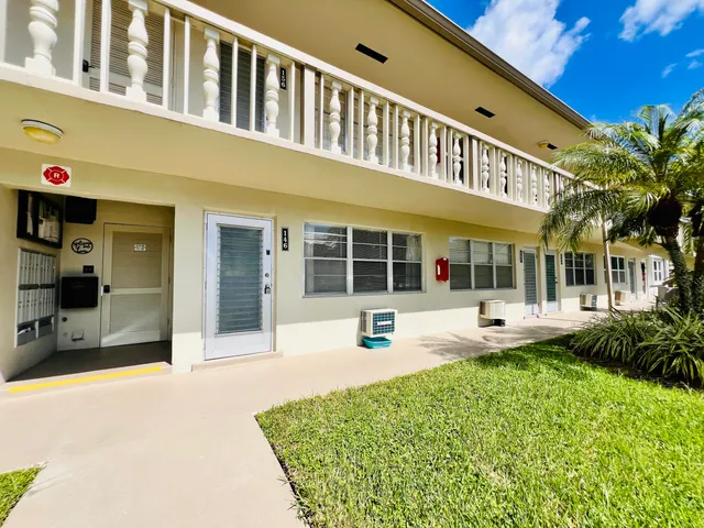 a view of a house with sitting area and garden