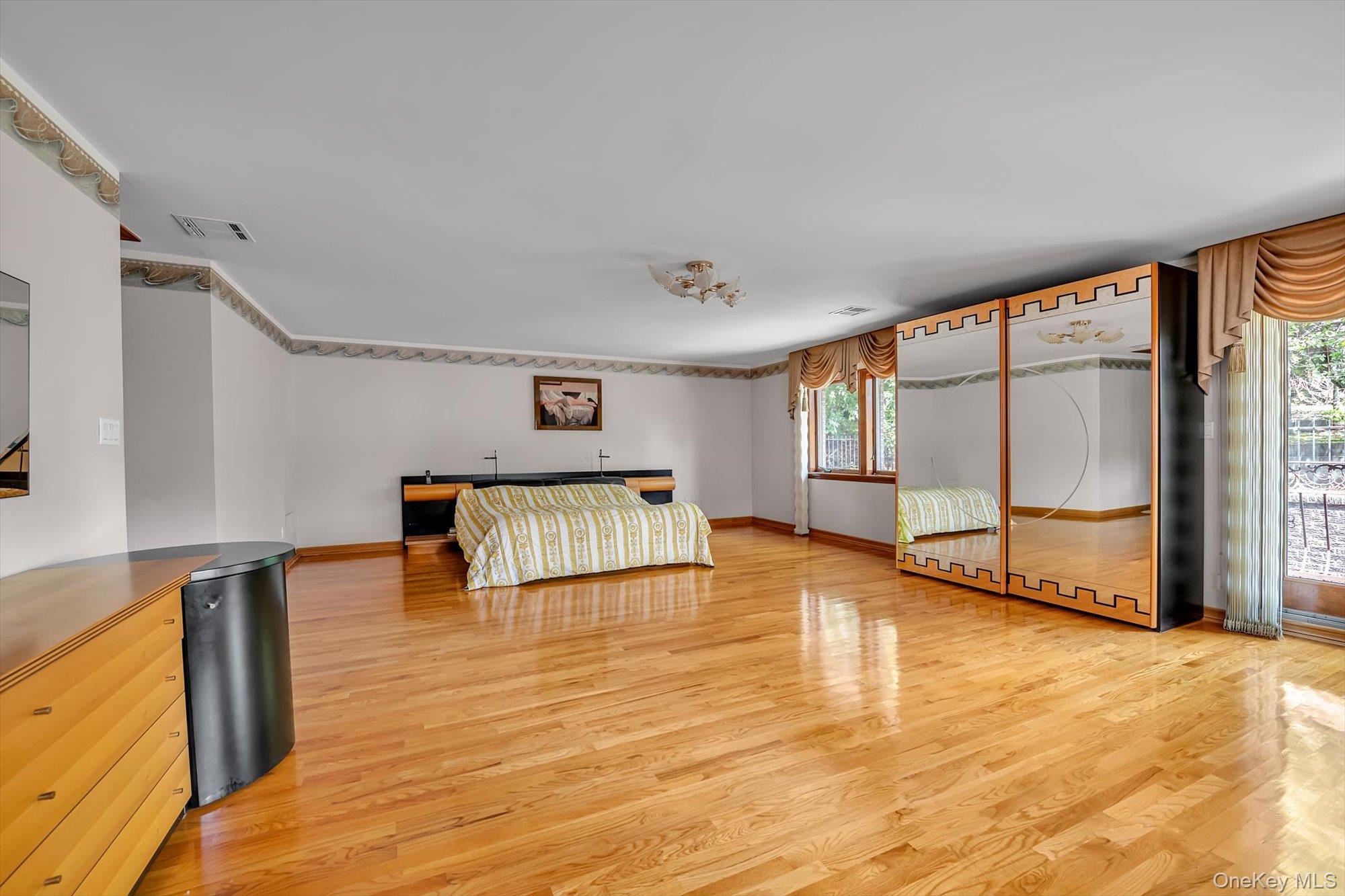 180-42 Aberdeen Road Queens, NY 11432 - Photo 13 of 25 a spacious bedroom with a large bed and a large window