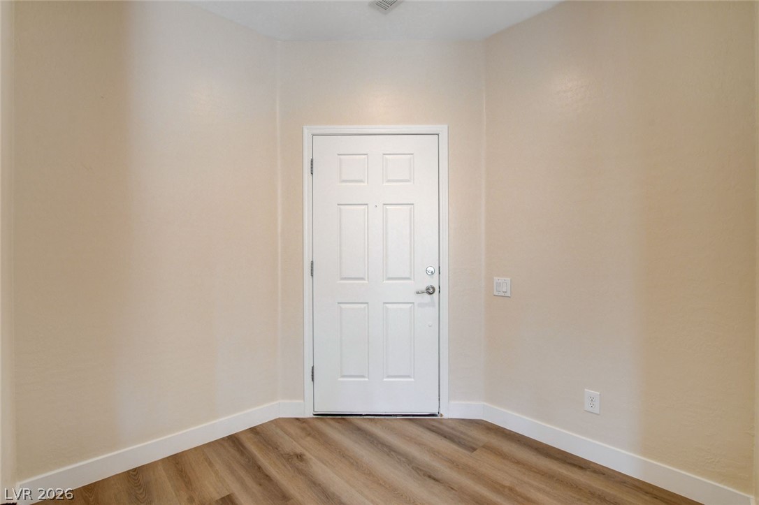 2649 Rue Marquette Avenue Henderson, NV 89044 - Photo 8 of 55 Welcome home to this inviting entry, boasting warm-toned flooring and a pristine white door.