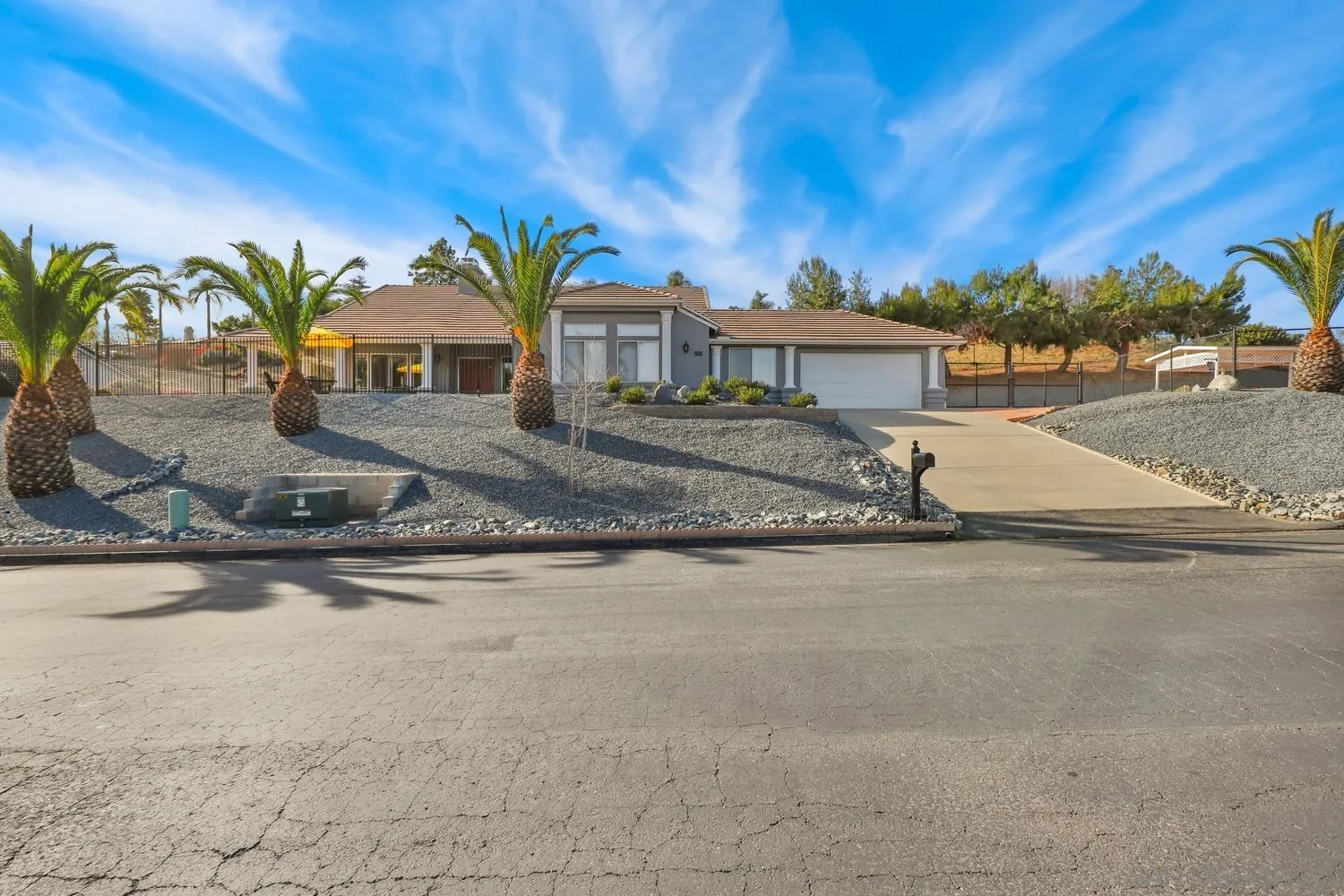 a front view of a house with a yard and parking space