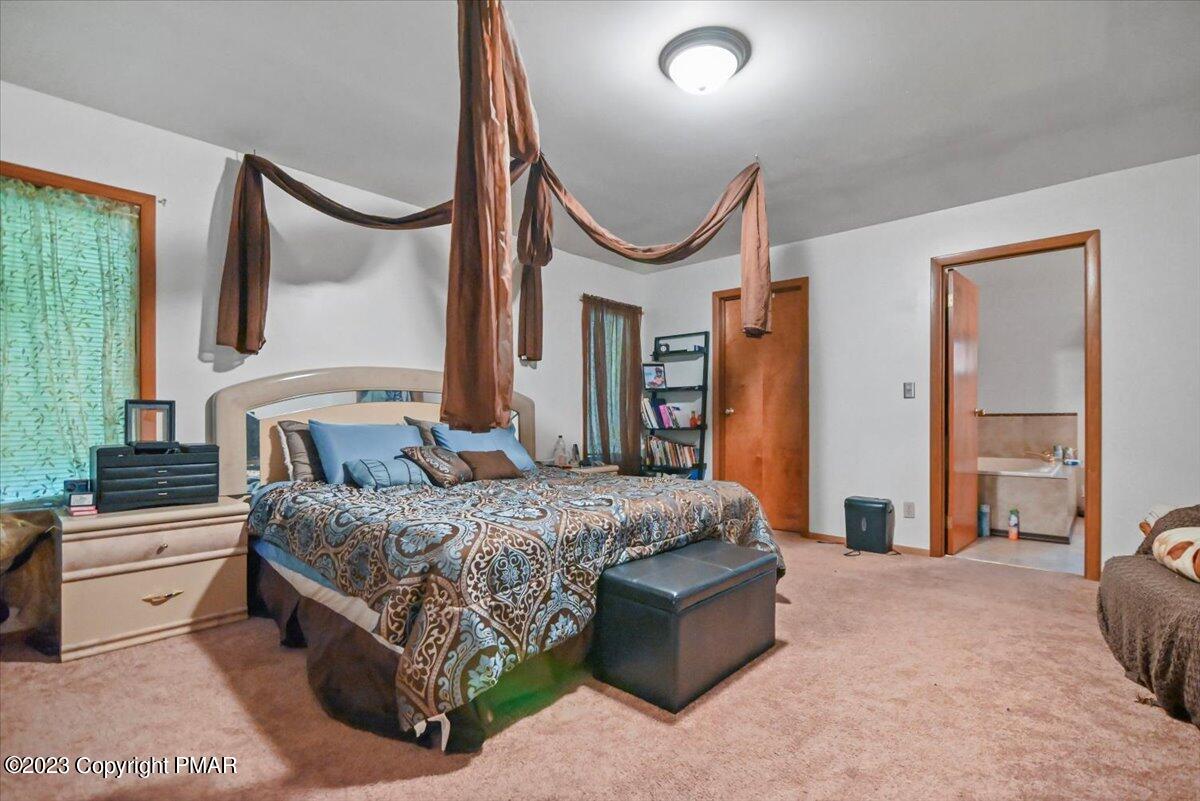 3237 Windemere Drive Bushkill, PA 18324 - Photo 20 of 50 a bedroom with a large bed and a large window