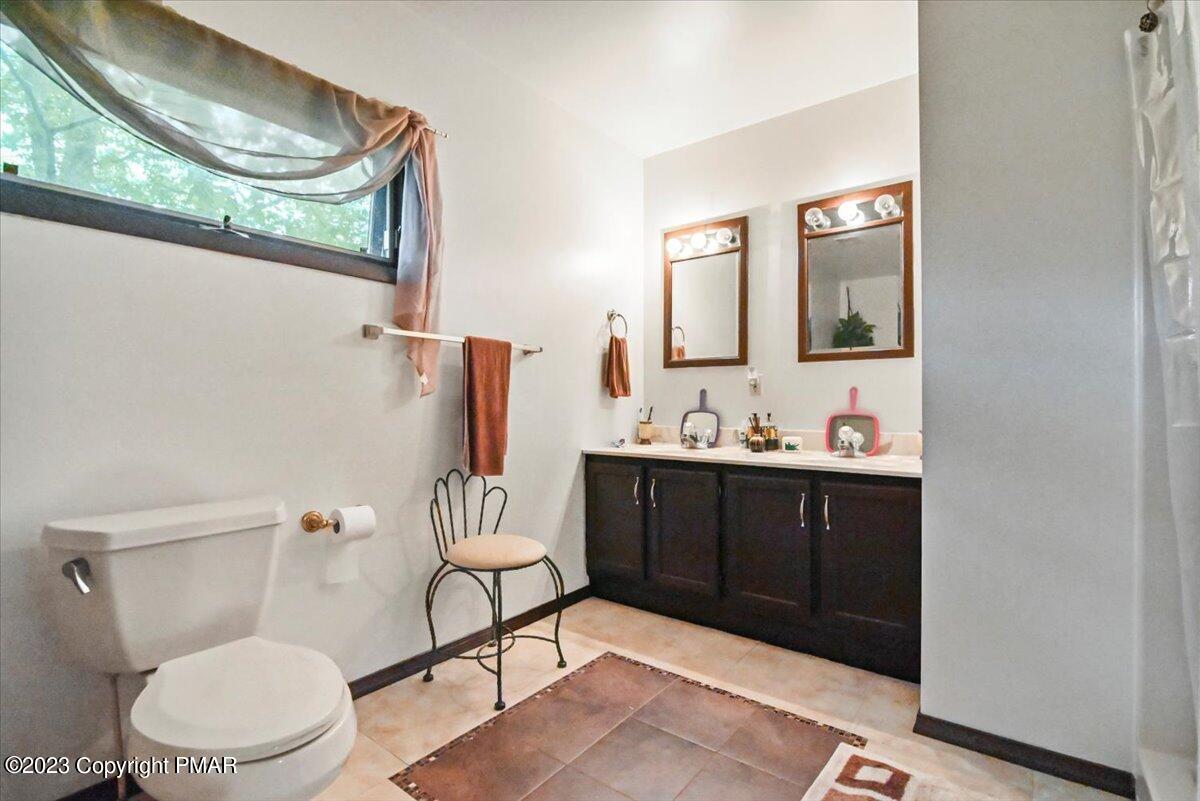 3237 Windemere Drive Bushkill, PA 18324 - Photo 22 of 50 a bathroom with a sink vanity mirror and toilet