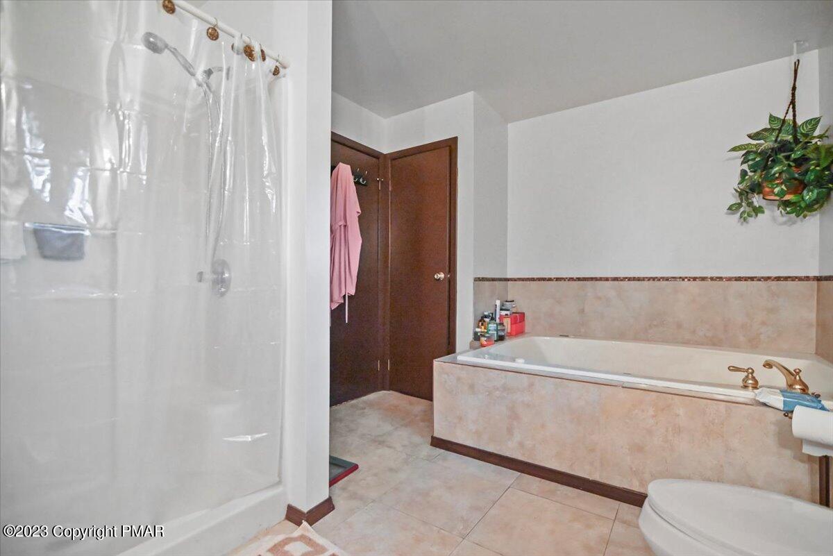 3237 Windemere Drive Bushkill, PA 18324 - Photo 23 of 50 a bathroom with a bathtub and shower