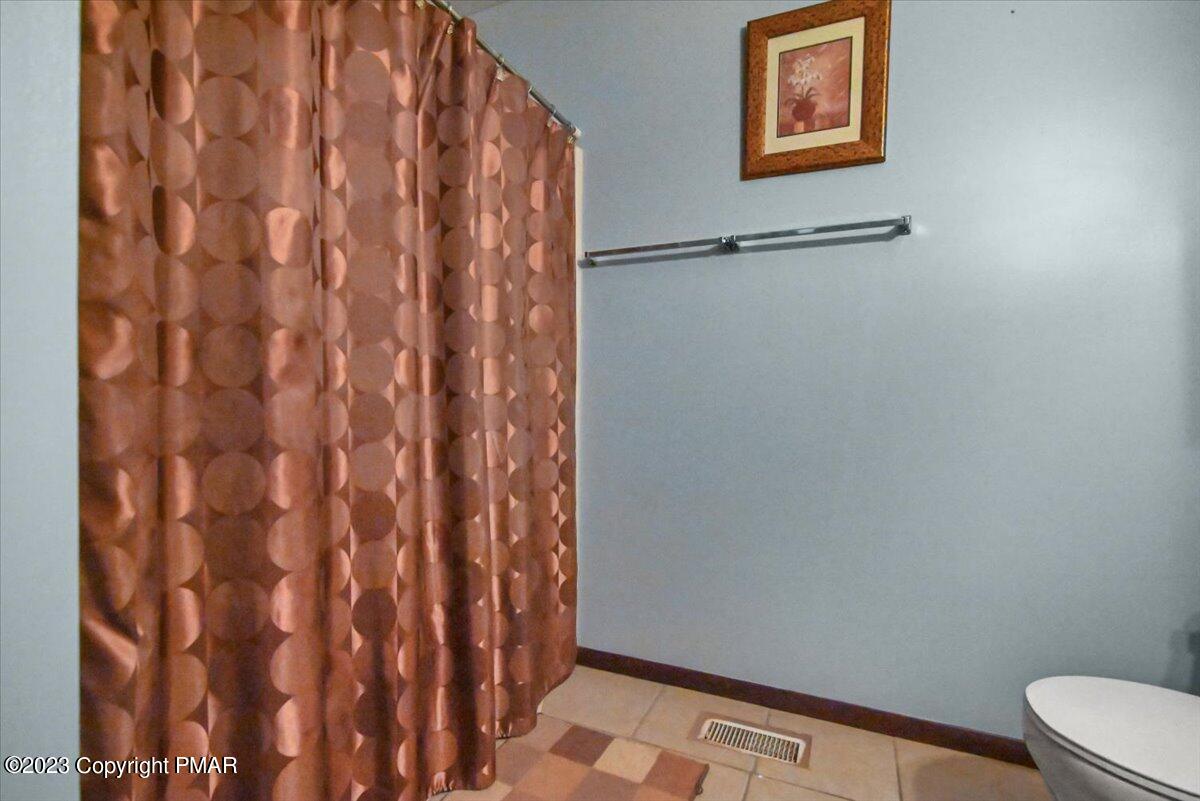 3237 Windemere Drive Bushkill, PA 18324 - Photo 24 of 50 a bathroom with a shower curtain