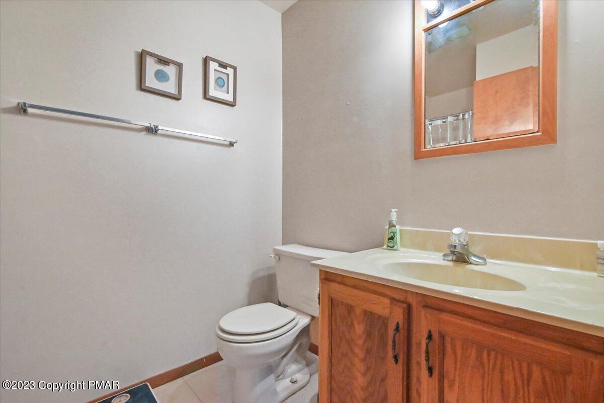 3237 Windemere Drive Bushkill, PA 18324 - Photo 27 of 50 a bathroom with a granite countertop sink toilet and a mirror