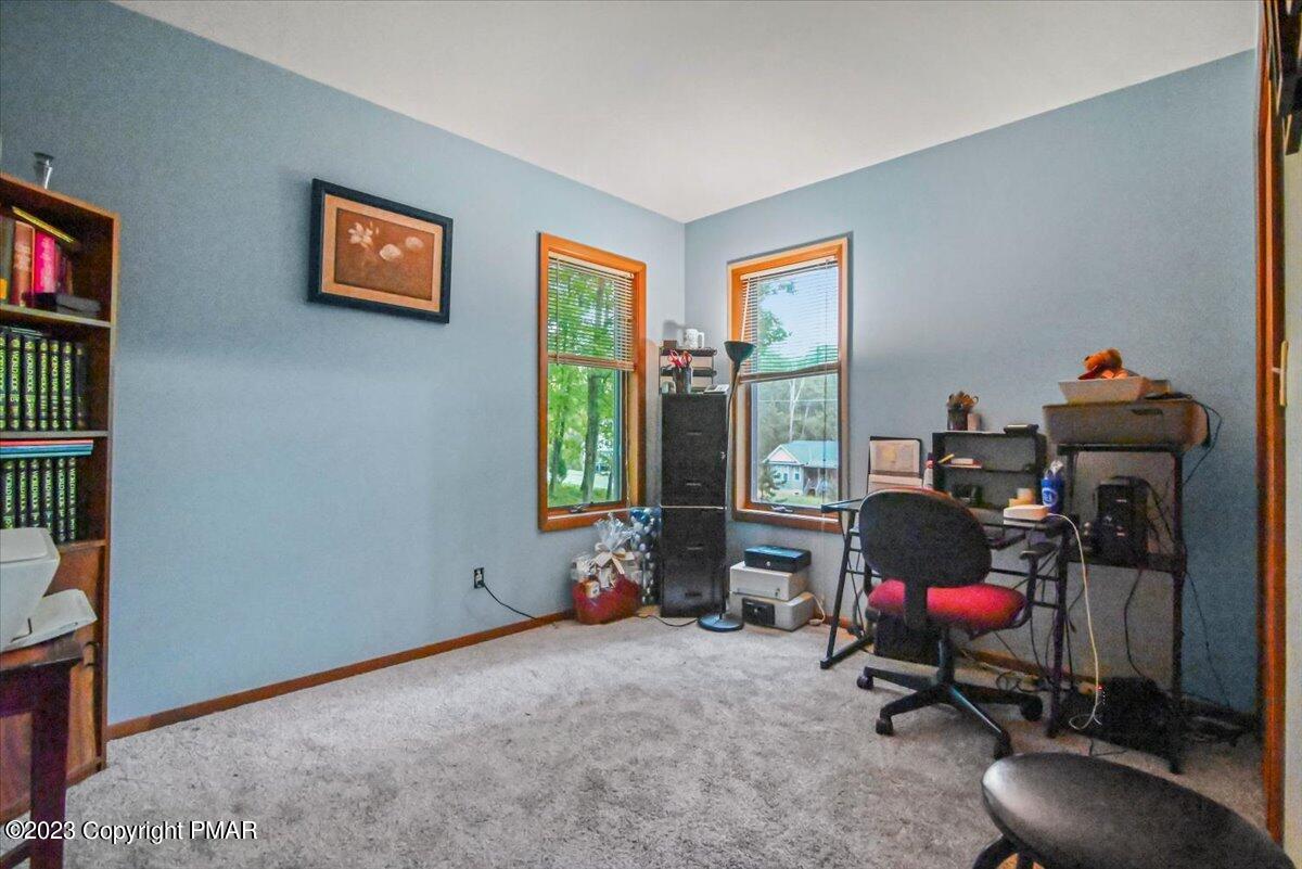 3237 Windemere Drive Bushkill, PA 18324 - Photo 36 of 50 a room with furniture and a floor to ceiling window