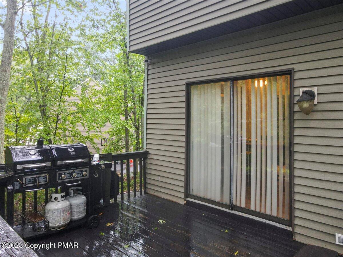 3237 Windemere Drive Bushkill, PA 18324 - Photo 45 of 50 a view of a patio with table and chairs and wooden floor