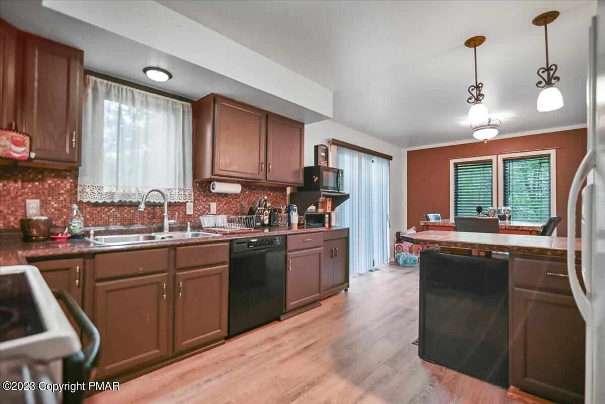 3237 Windemere Drive Bushkill, PA 18324 - Photo 7 of 50 a kitchen with stainless steel appliances granite countertop a sink stove and refrigerator