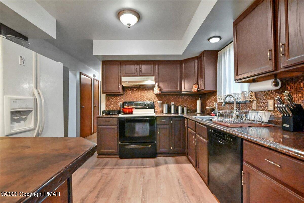 3237 Windemere Drive Bushkill, PA 18324 - Photo 8 of 50 a kitchen with stainless steel appliances granite countertop a sink stove and refrigerator