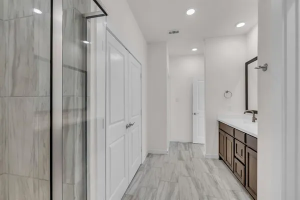 a view of a hallway with wooden floor