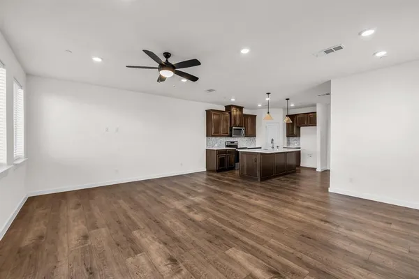 a view of kitchen with microwave and cabinets
