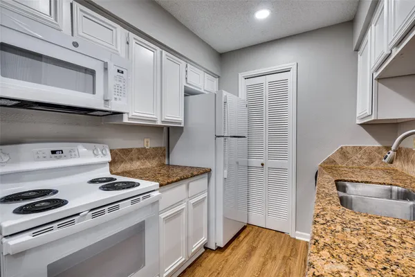 a kitchen with a stove and a refrigerator