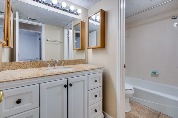 a bathroom with a bathtub a sink a toilet and a shower