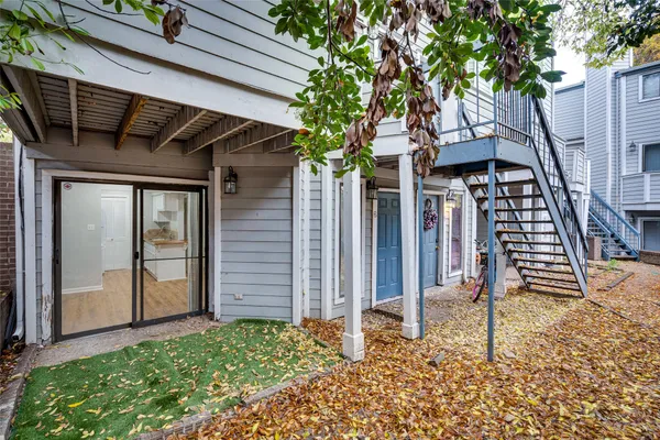 a backyard of a house with table and chairs