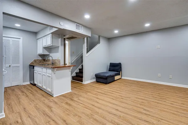 a kitchen with stainless steel appliances granite countertop a sink and a stove top oven