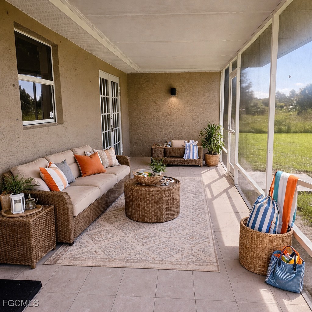 3780 Randall Boulevard Naples, FL 34120 - Photo 11 of 12 a living room with furniture and a flat screen tv