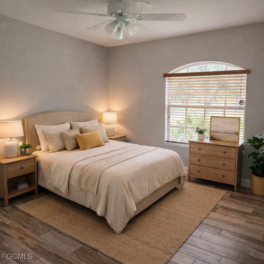 3780 Randall Boulevard Naples, FL 34120 - Photo 8 of 12 a bedroom with a large bed and a chandelier