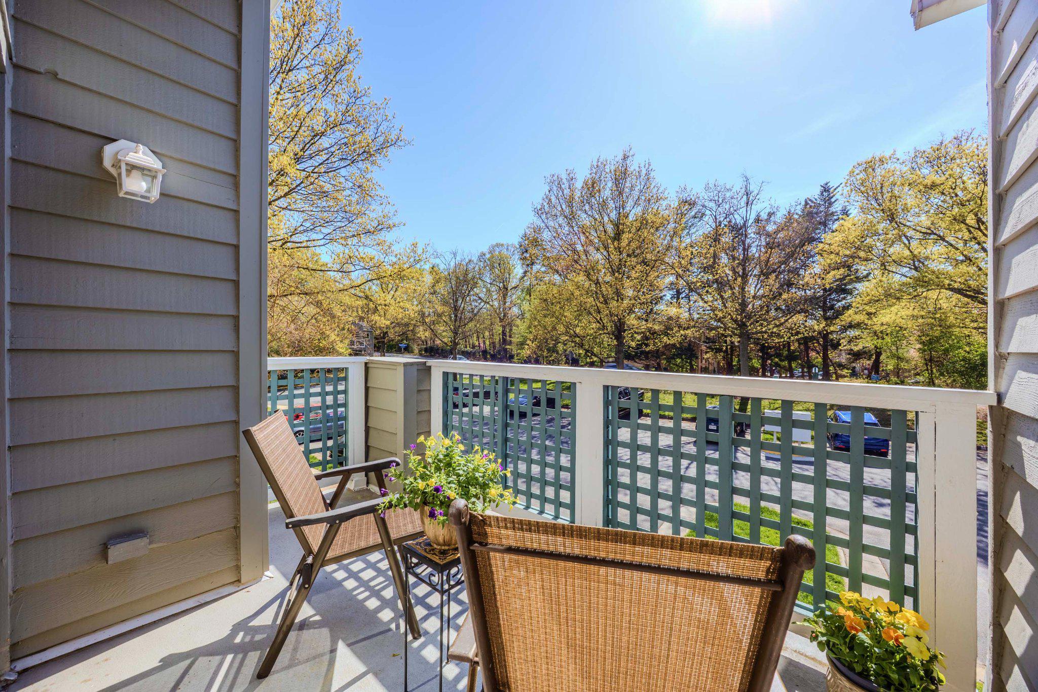 11703 Summerchase Circle, Unit B Reston, VA 20194 - Photo 1 of 22 Living room opens to balcony with lush greenery.