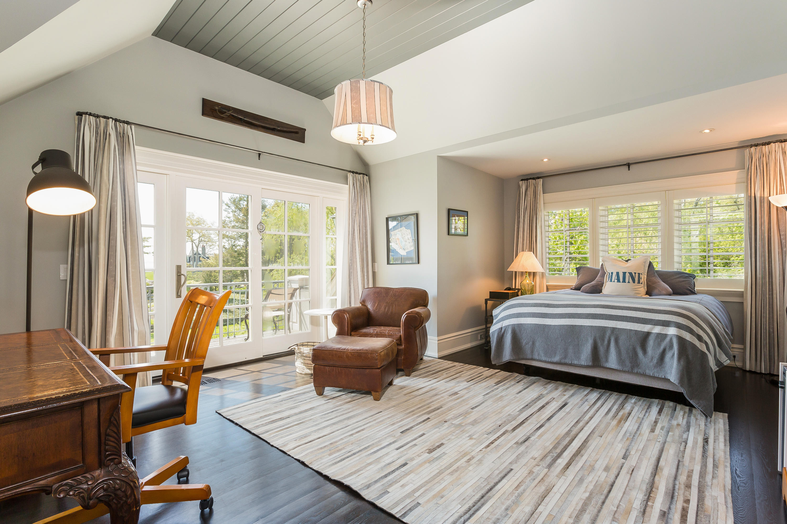 8 N Road Darien, CT 06820 - Photo 42 of 68 a spacious bedroom with a bed a chandelier and large window
