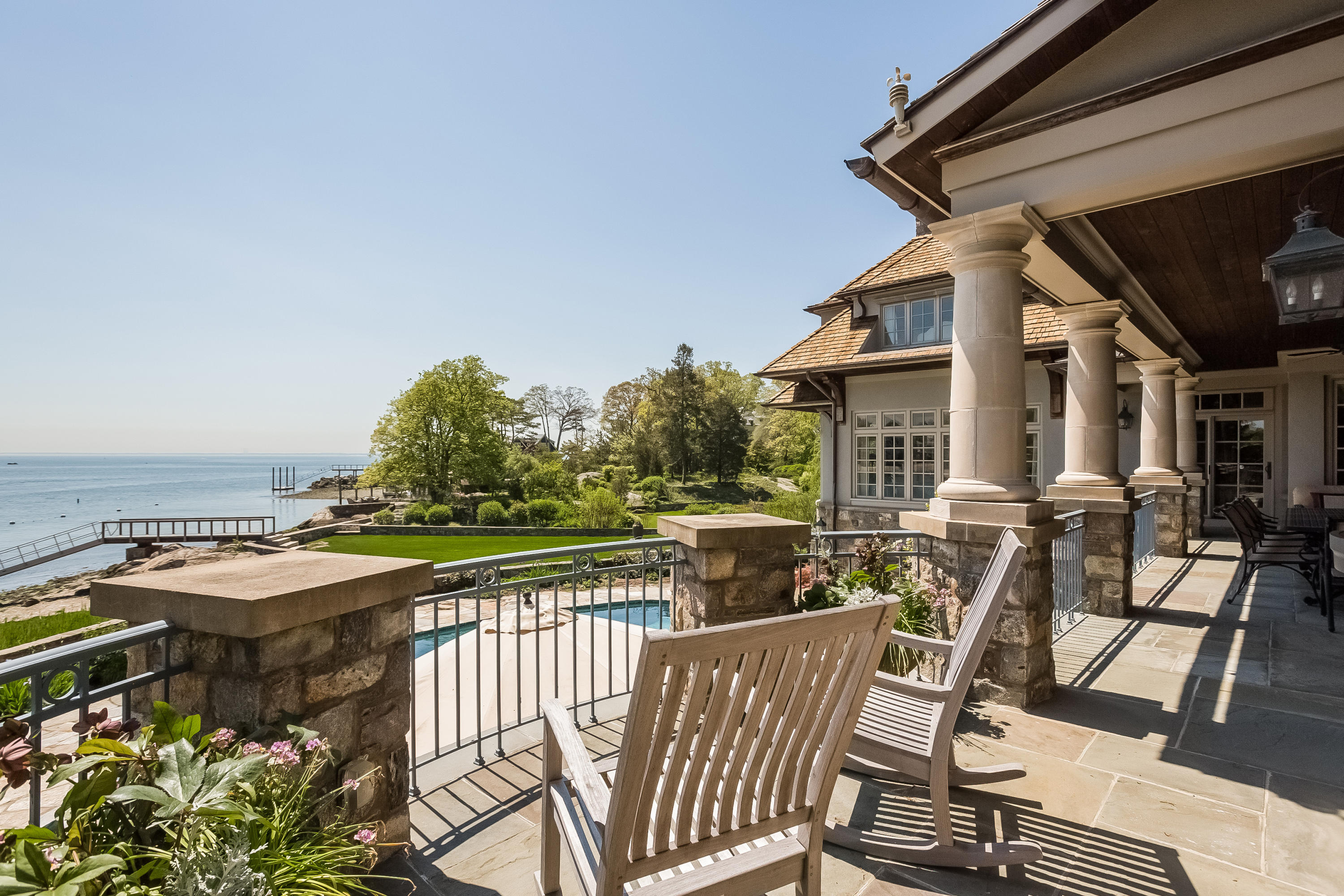 8 N Road Darien, CT 06820 - Photo 56 of 68 a view of a patio with table and chairs with wooden floor and fence