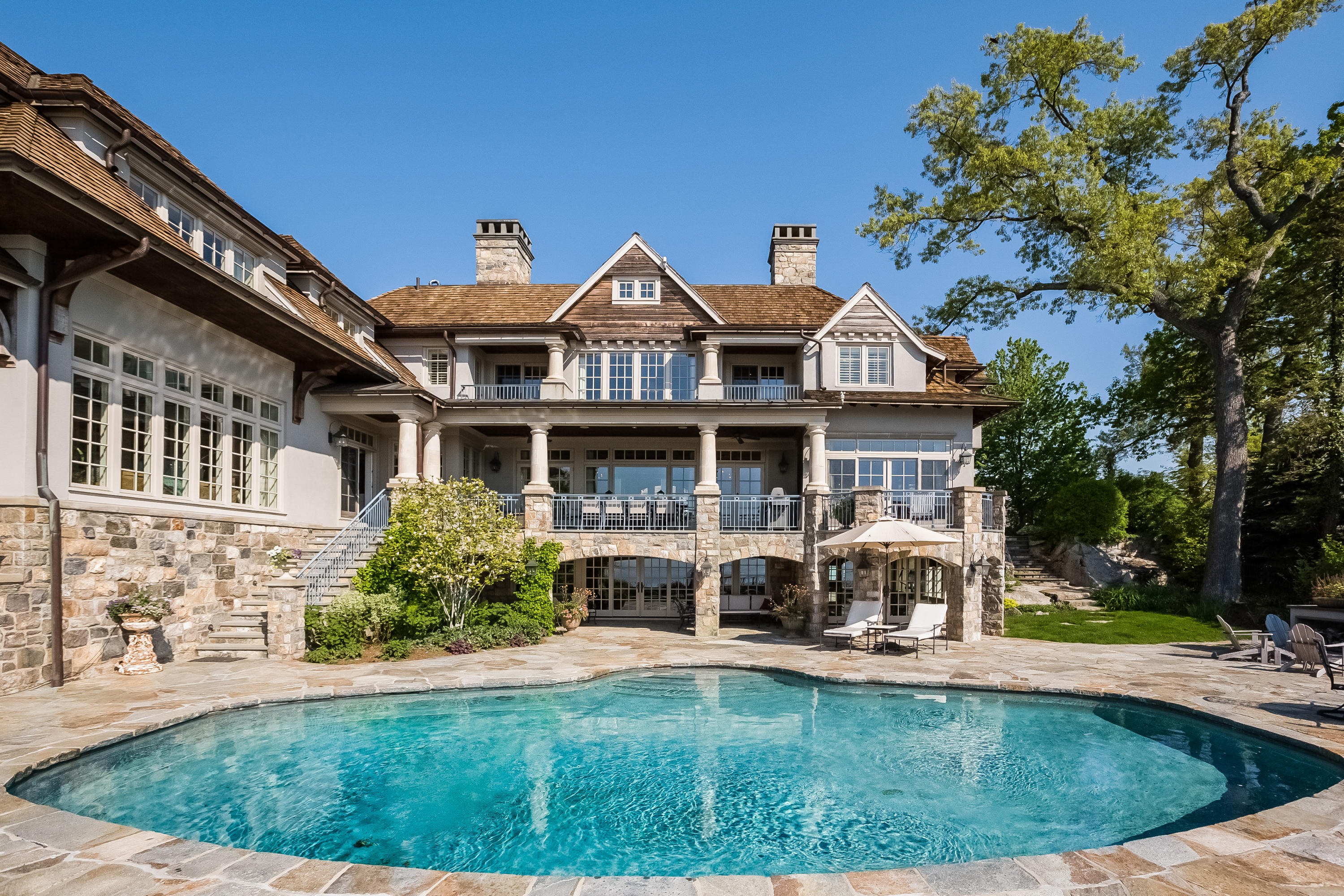 8 N Road Darien, CT 06820 - Photo 59 of 68 a front view of a house with swimming pool having outdoor seating