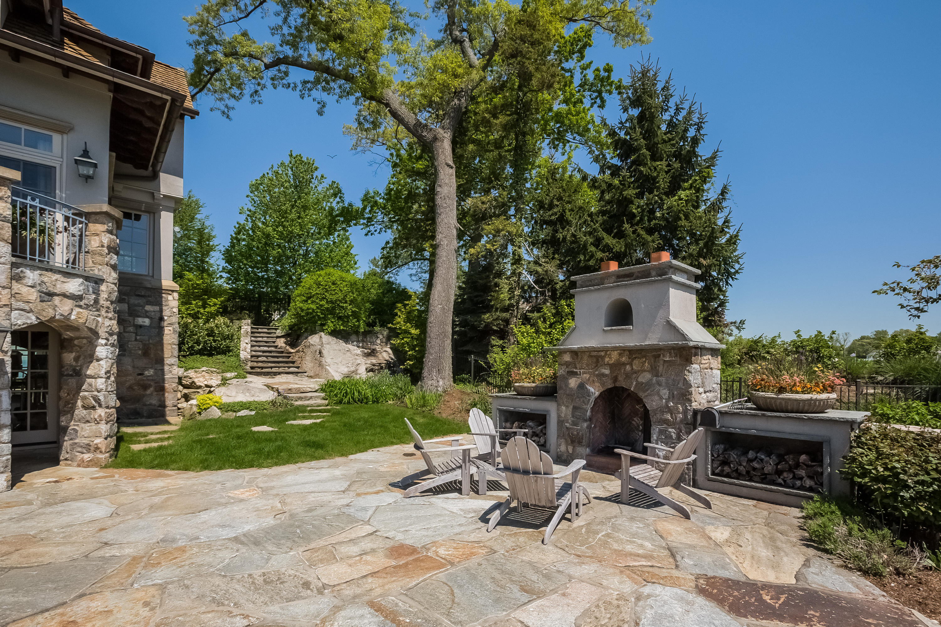 8 N Road Darien, CT 06820 - Photo 61 of 68 a view of a chair and tables in the patio in front of a house