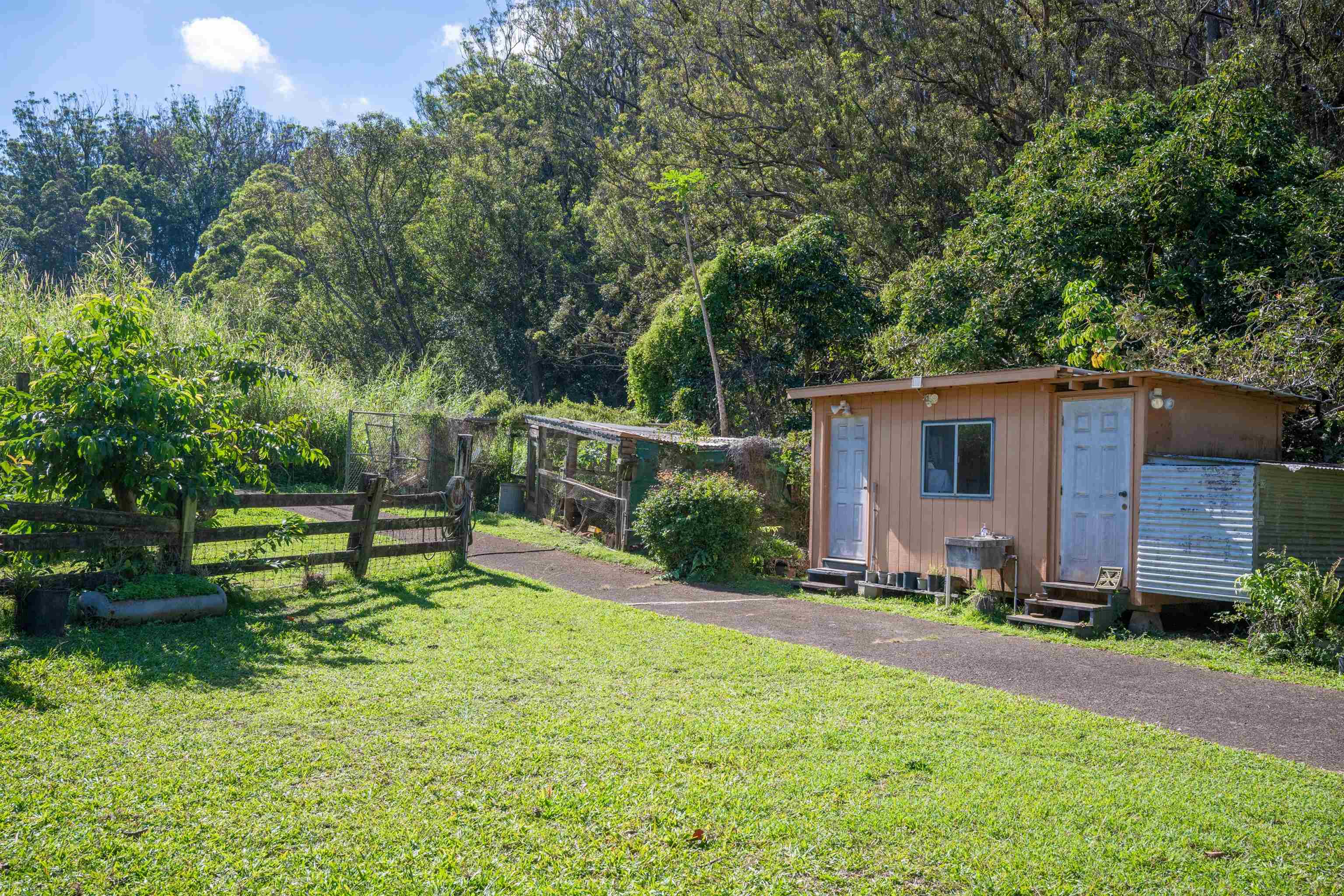 2475 Kaupakalua Road Haiku, HI 96708 - Photo 3 of 28 a view of a house with a yard and sitting area