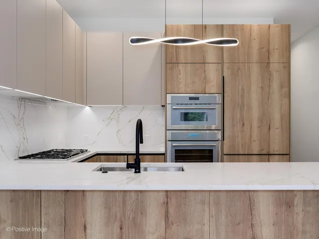 a kitchen with a refrigerator and a stove