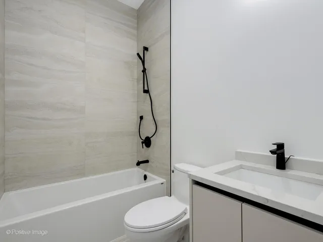 a bathroom with a sink a toilet and a bathtub
