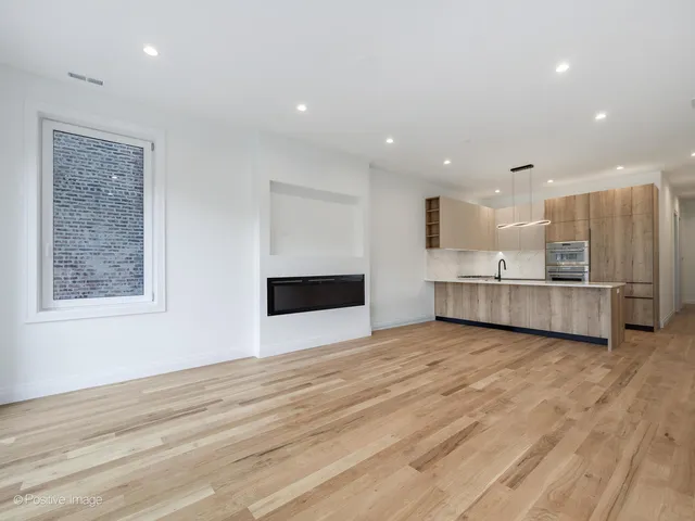 a view of a kitchen with a sink and a fireplace