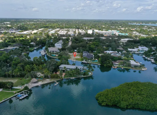 an aerial view of residential houses with outdoor space and lake view