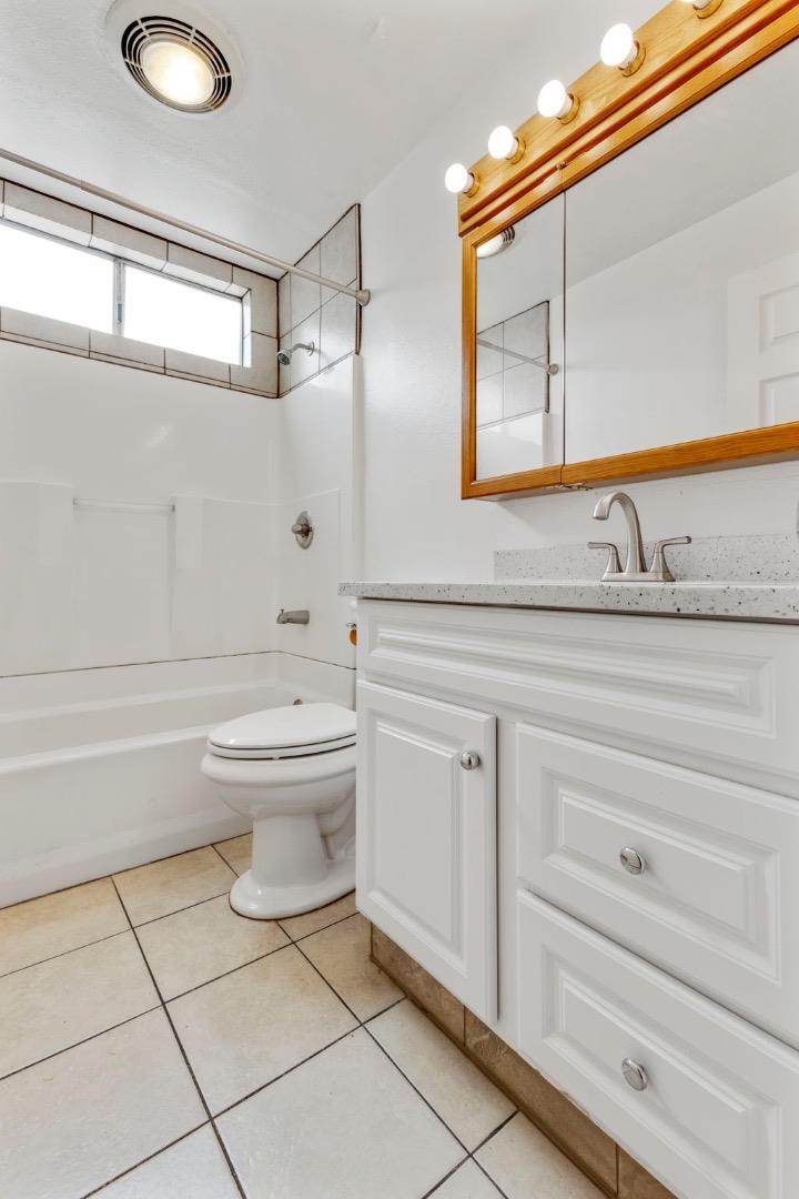 1604 Cherokee Drive Salinas, CA 93906 - Photo 14 of 22 a bathroom with a granite countertop toilet sink and mirror