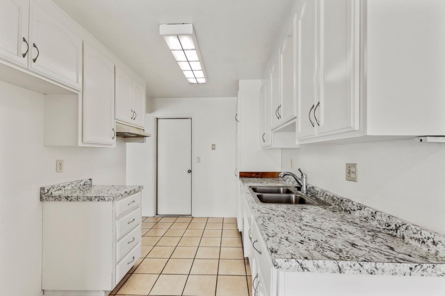 1604 Cherokee Drive Salinas, CA 93906 - Photo 10 of 22 a kitchen with granite countertop white cabinets and appliances