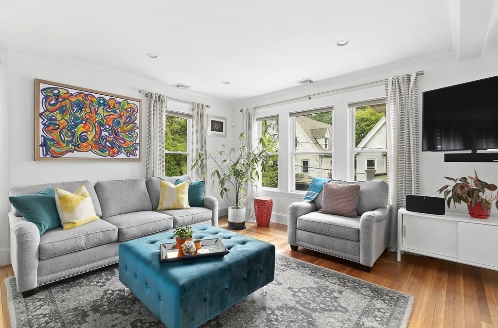 20 Hall Avenue, Unit 2 Somerville, MA 02144 - Photo 2 of 18 a living room with furniture a flat screen tv and a large window