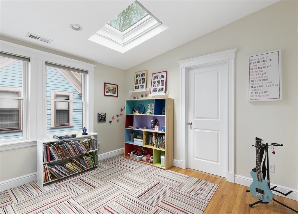 20 Hall Avenue, Unit 2 Somerville, MA 02144 - Photo 8 of 18 a view of a livingroom with furniture and a bookshelf