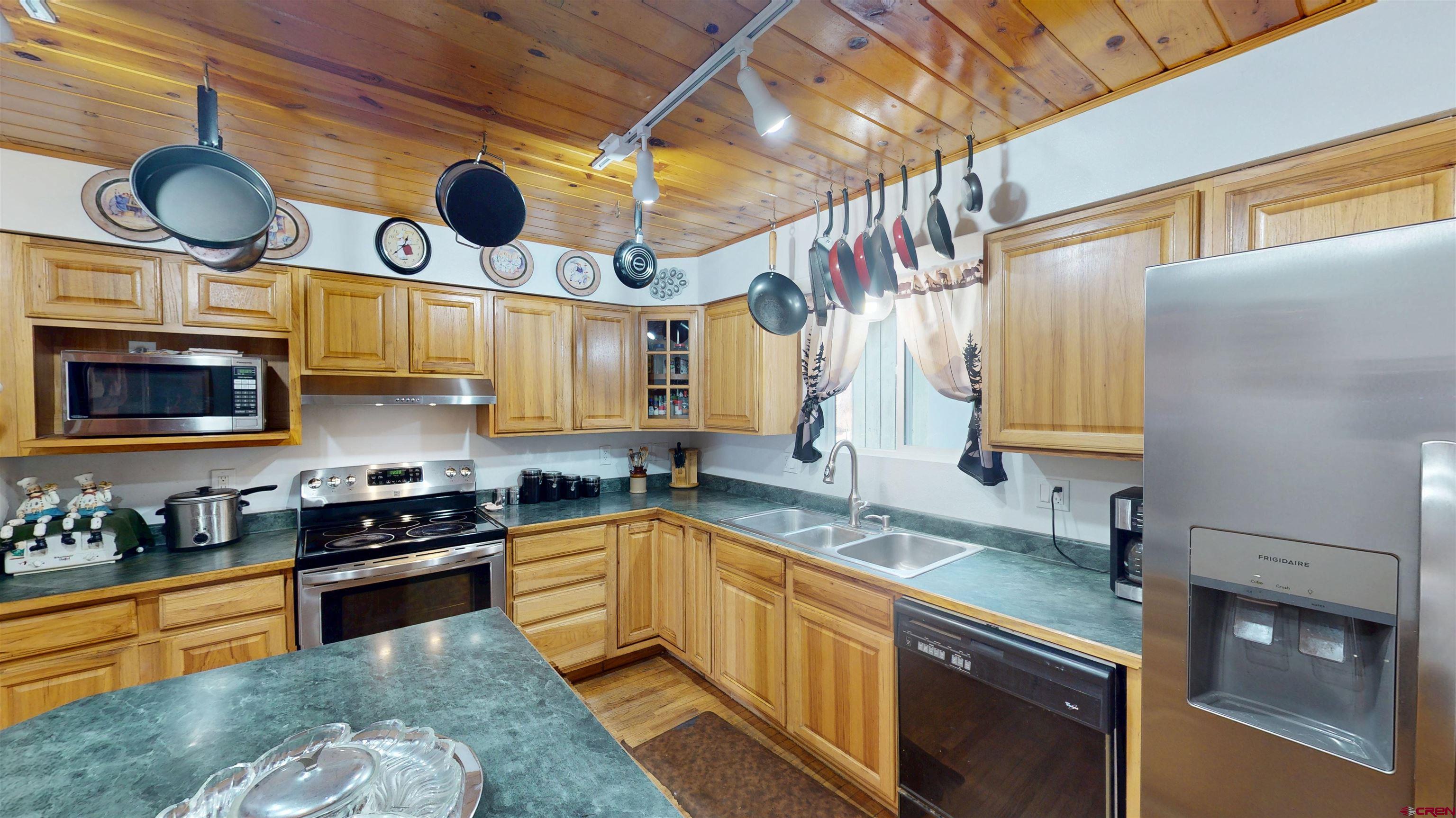 19253 Stevens Gulch Road Paonia, CO 81428 - Photo 21 of 43 a kitchen with stainless steel appliances granite countertop a sink a stove and cabinets