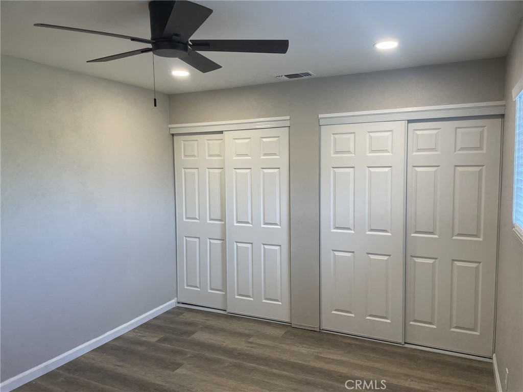 820 North Lassen Street Willows, CA 95988 - Photo 12 of 18 an empty room with wooden floor closet fan and windows