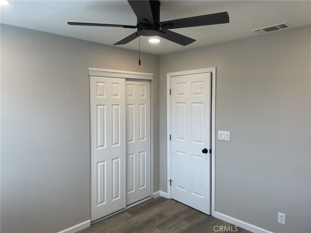 820 North Lassen Street Willows, CA 95988 - Photo 15 of 18 an empty room with wooden floor and fan